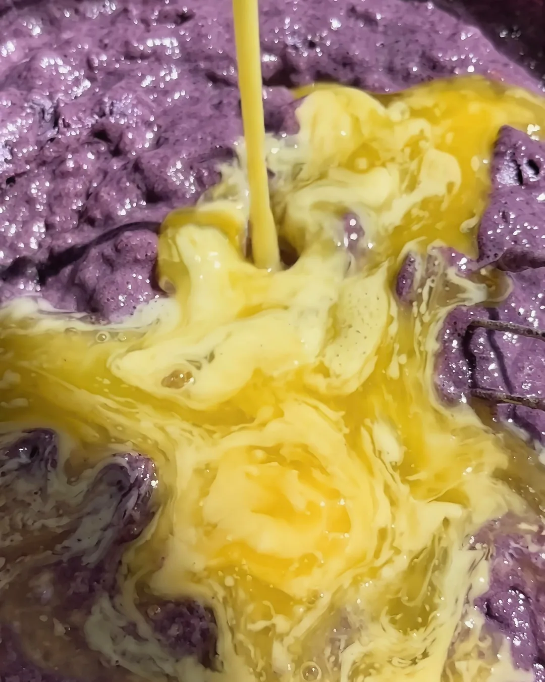 Æg hældes i den lilla ube-banana bread-dej | Ube Nolia